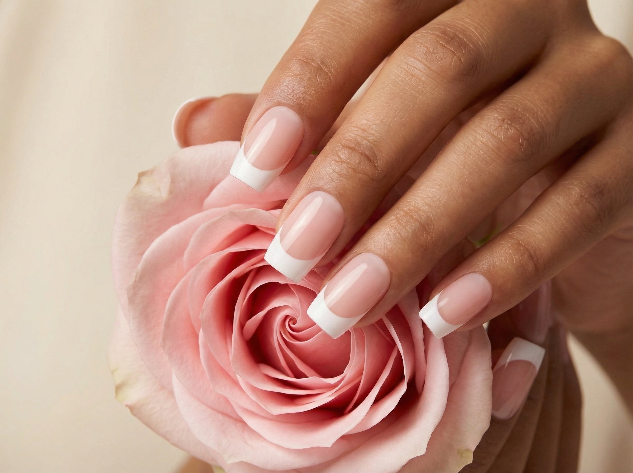 Classic French Tips press-on nails - lifestyle shot with rose