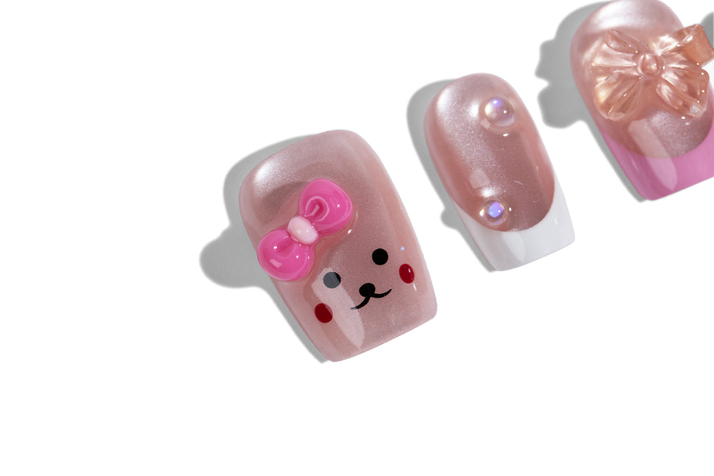 Pink bear press-on nails - macro close-up of the bear-face accent nail