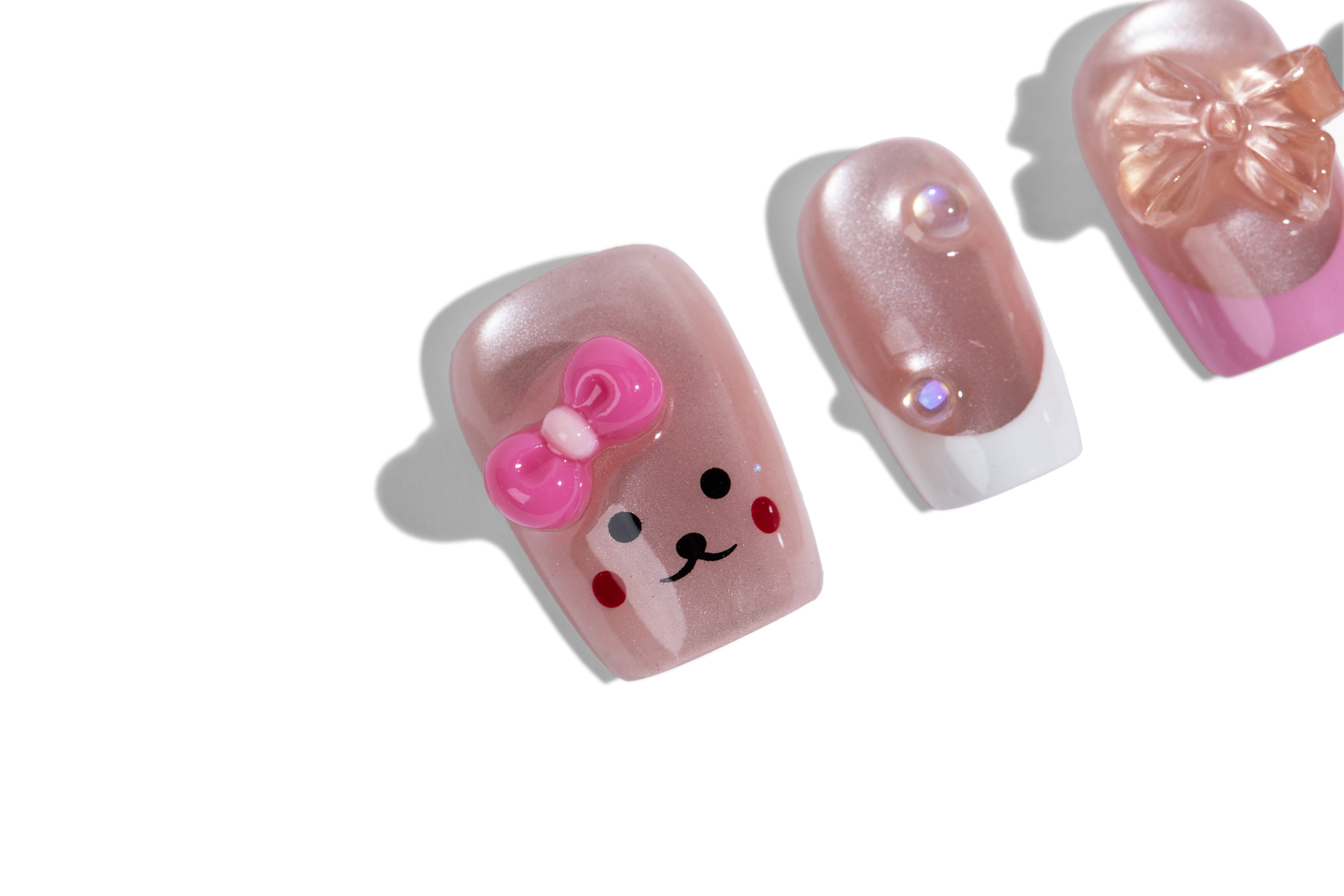 Pink bear press-on nails - macro close-up of the bear-face accent nail